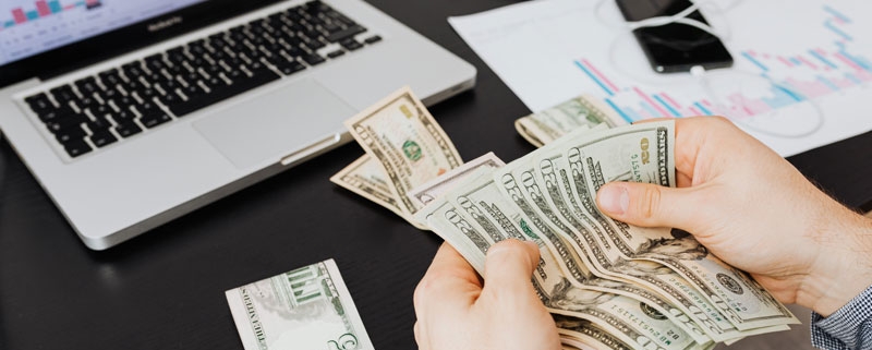 man counting money as final step in Unclaimed Property Deadline check list