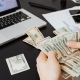 man counting money as final step in Unclaimed Property Deadline check list